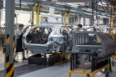 Rusya, Izhevsk - 15 Aralık 2018: Lada Otomobil Fabrikası Izhevsk. İşçiler yeni bir arabanın gövdesine kapı koydular..