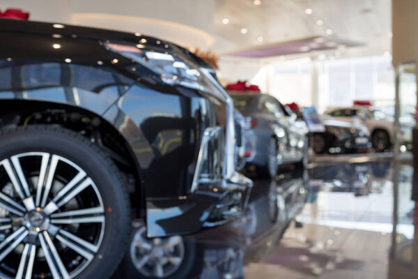Car auto dealership.Themed blur background with bokeh effect. New cars at dealer showroom.