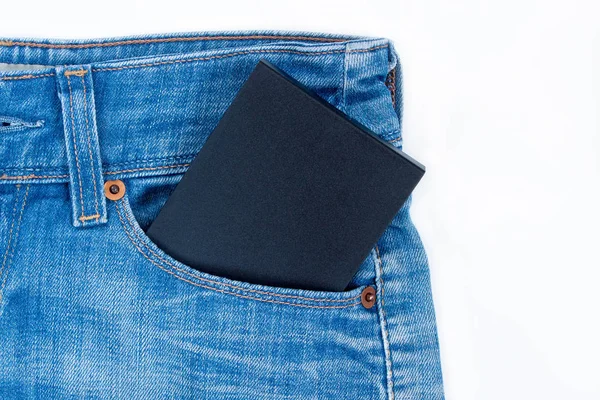 External hard drive in side pocket of blue jeans.