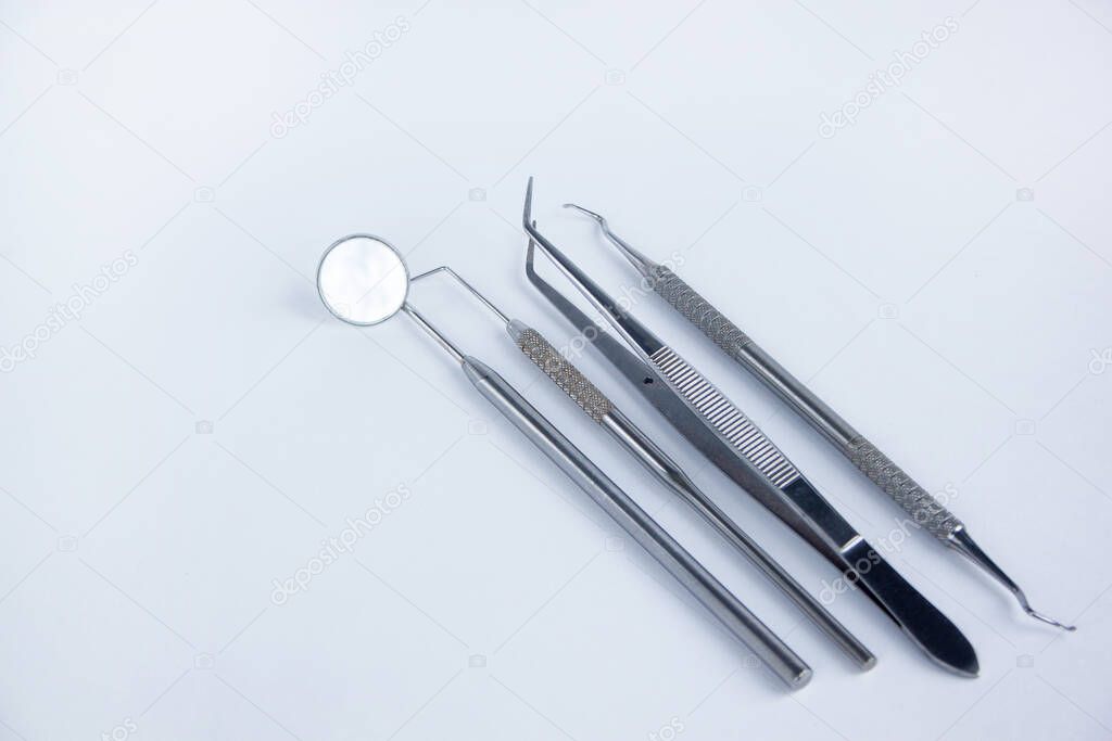 Group of dental tools for the treatment of teeth. Isolated on white background.
