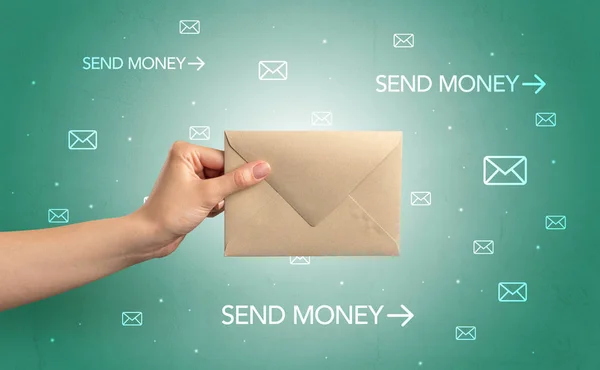 Hand holding envelope with symbols around — Stock Photo, Image