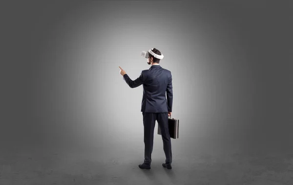 Businessman in an empty room with vr glasses