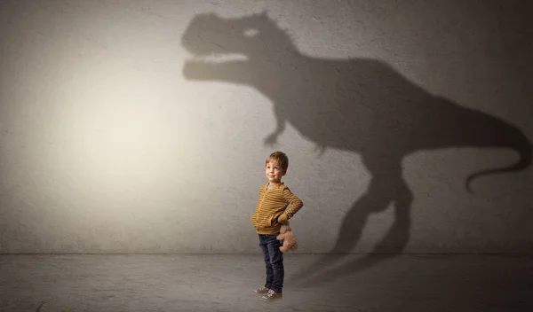 Dinosaurus shadow behind cute boy — Stock Photo, Image