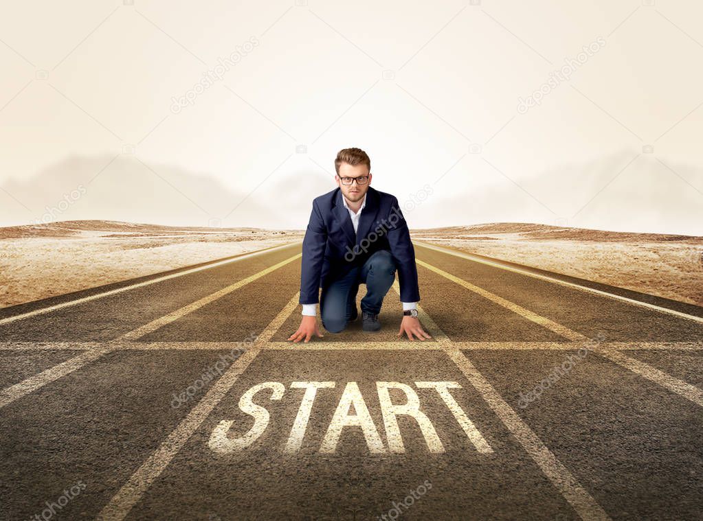 Businessman kneeling in ready position