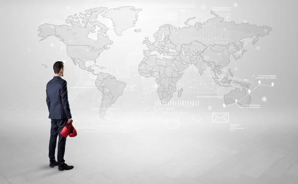 Man looking at map with objects in his hand — Stock Photo, Image