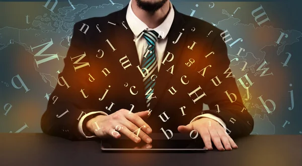 Man typing in formal clothing and letters around — Stock Photo, Image