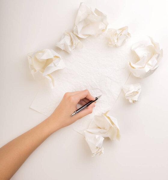 Writing hand in crumpled paper