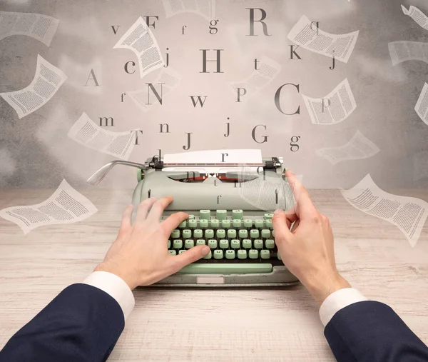 Hand typewriting with flying documents around — Stock Photo, Image