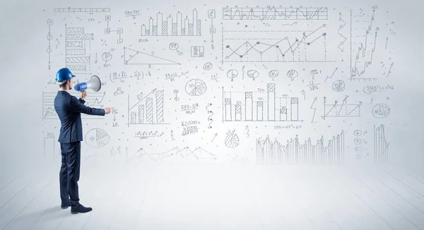 Engineer holding a plan and standing with graphs, charts and reports on the background — Stock Photo, Image