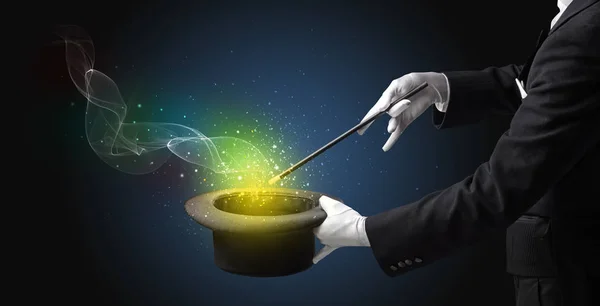 Illusionist hand making trick with wand — Stock Photo, Image