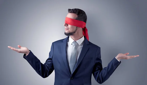 Covered eye businessman in front of a wall — Stock Photo, Image