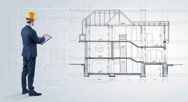 Architekt při pohledu na plán domu — Stock fotografie