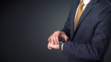 Smartwatch giyen takım elbiseli adam.