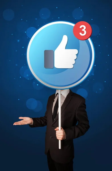 Businessman holding facebook sign — Stock Photo, Image