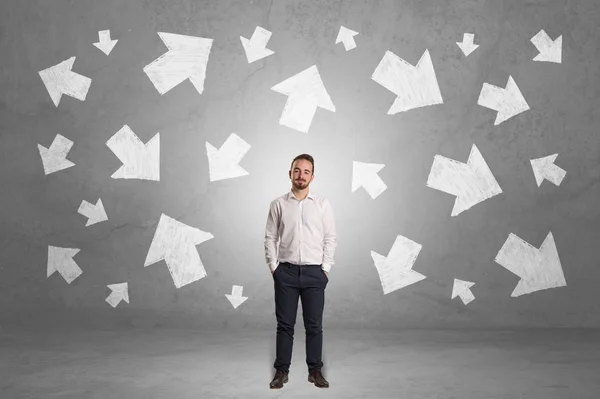 Businessman standing with arrows around — Stock Photo, Image