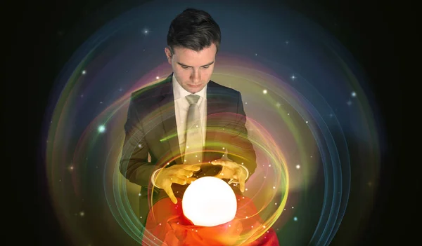 Man looking to the future of the word in a magic ball — Stock Photo, Image