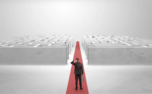 Businessman going straight ahead between two mazes — Stock Photo, Image