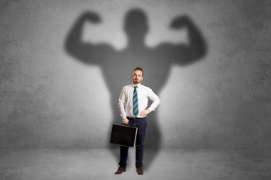 Businessman with muscular shade behind his back clipart