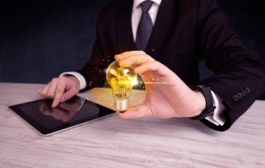 bir ampul tutarak ofis çalışanı