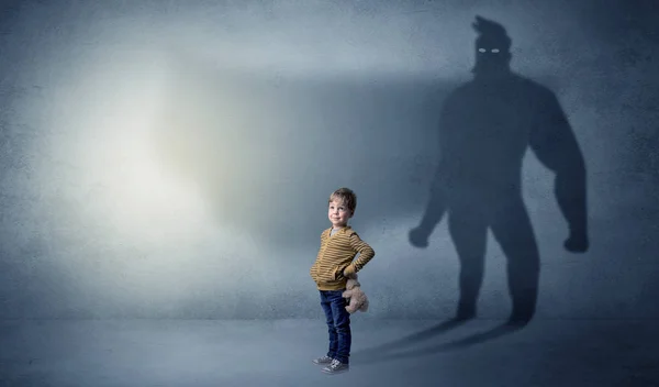 Cute kid with hero shadow behind — Stock Photo, Image