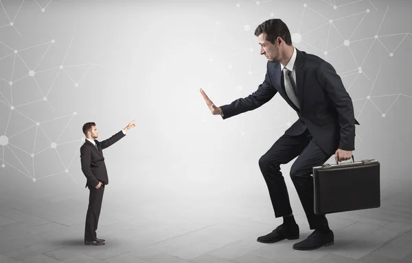 Small man aiming at a big man with network concept — Stock Photo, Image