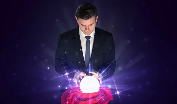 Businessman sitting with crystal ball in action — Stock Photo, Image