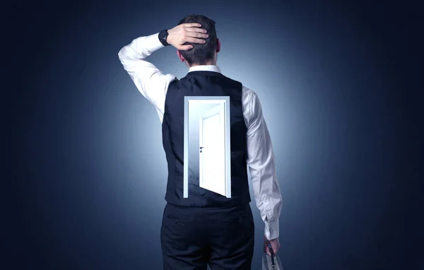 Businessman standing with door on his back — Stock Photo, Image