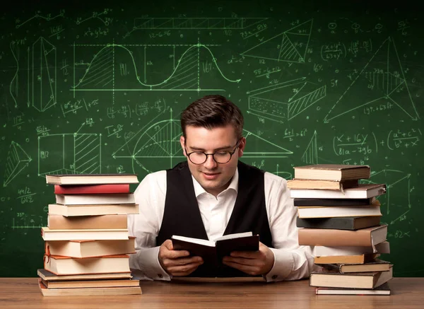 Young Passionate Male Teacher Sitting School Desk Reading Book Area — Stock Photo, Image