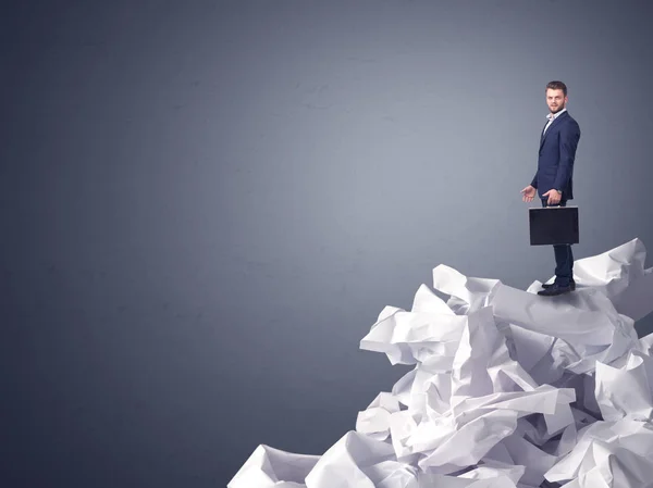 Businessman standing on crumpled paper — Stock Photo, Image