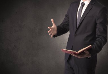 Elinde kitap tutan bir işadamı.