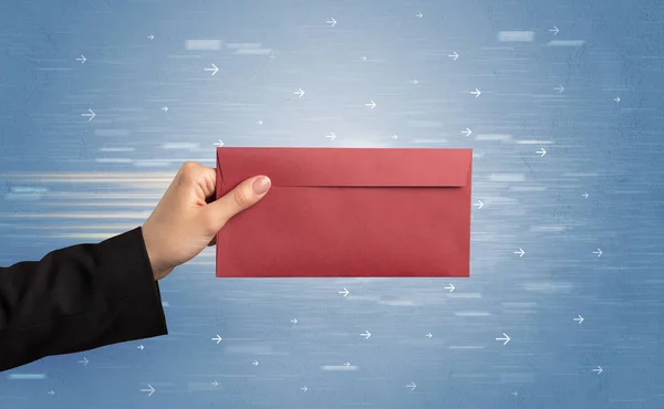 Hand holding envelope with arrows around — Stock Photo, Image