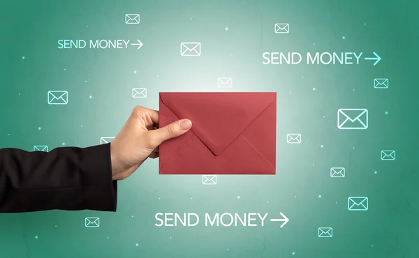 Hand holding envelope with symbols around — Stock Photo, Image