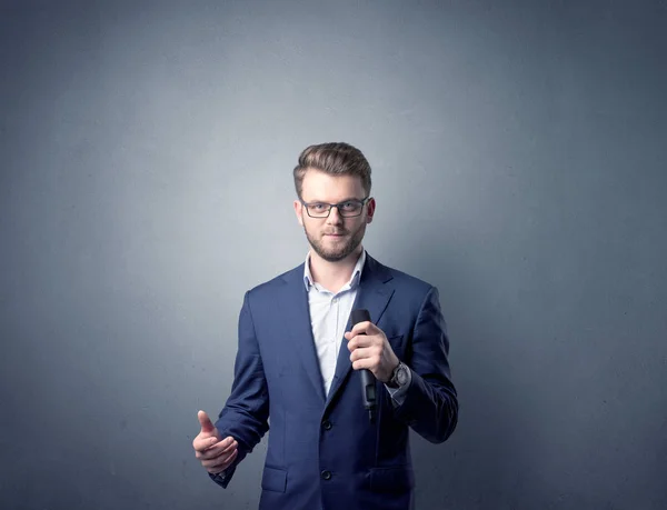 Businessman holding microphone — Stock Photo, Image