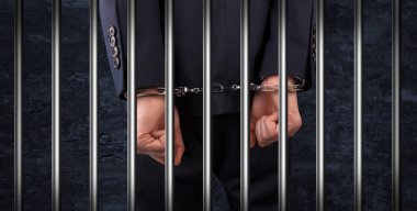 Close handcuffed man in jail clipart