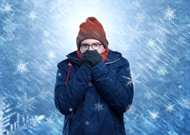 Boy freezing in warm clothing and snowing concept clipart