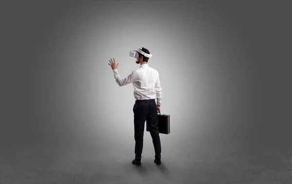 Businessman in an empty room with vr glasses — Stock Photo, Image