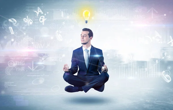 Businessman meditates with enlightenment concept — Stock Photo, Image