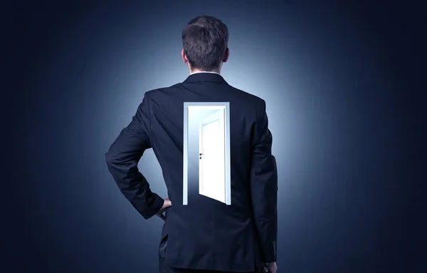 Businessman standing with door on his back — Stock Photo, Image