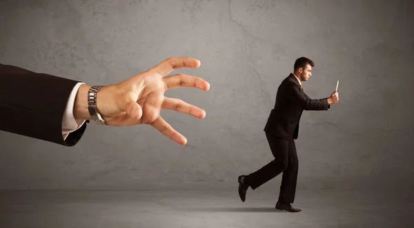 Businessman running from hand — Stock Photo, Image