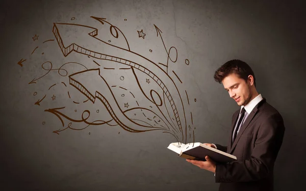 Young man holding book with arrows — Stock Photo, Image