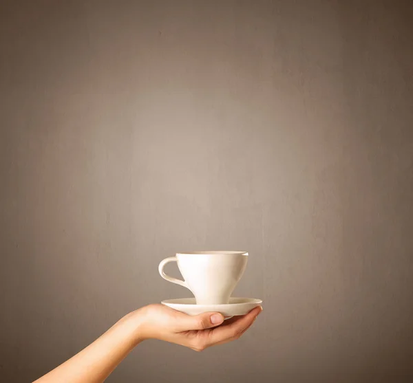 Vrouwelijke hand bedrijf koffie beker — Stockfoto