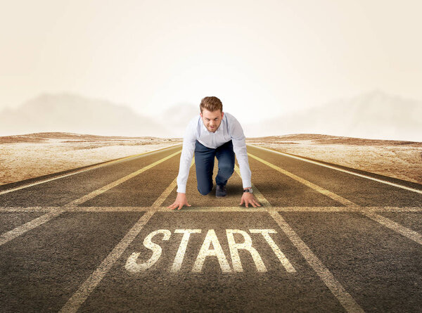 Businessman kneeling in ready position
