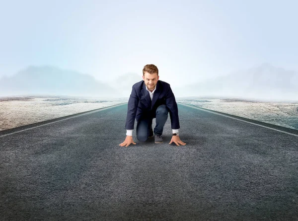 Businessman kneeling in ready position Stock Picture