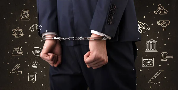 Symbols of courthouse with handcuffed man — Stock Photo, Image