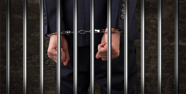 Close handcuffed man in jail