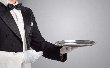 Waiter serving with white gloves and steel tray clipart