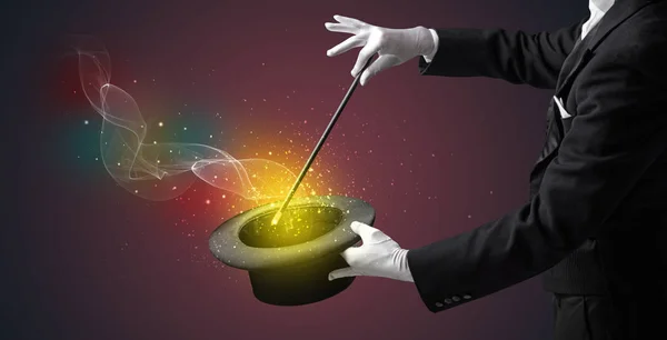 Illusionist hand making trick with wand — Stock Photo, Image