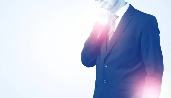 Young businessman standing and thinking — Stock Photo, Image