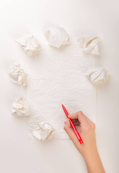 Writing hand in crumpled paper