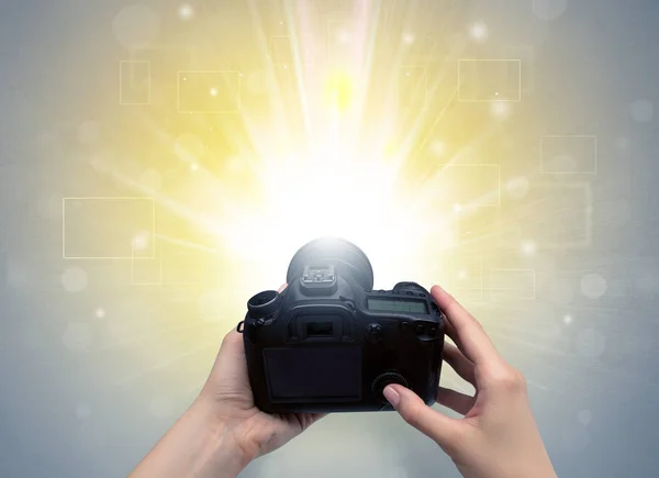 Hand taking photo with glowing flash concept — Stock Photo, Image